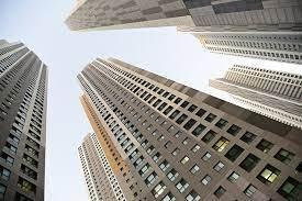 Looking up at tall buildings in London, specifically at the Wembley Park Gardens