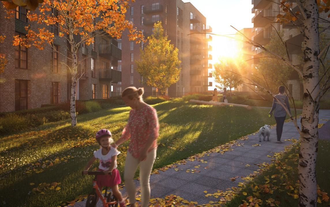 A woman and a child are walking down a path in autumn near Sterling Place Homes in London