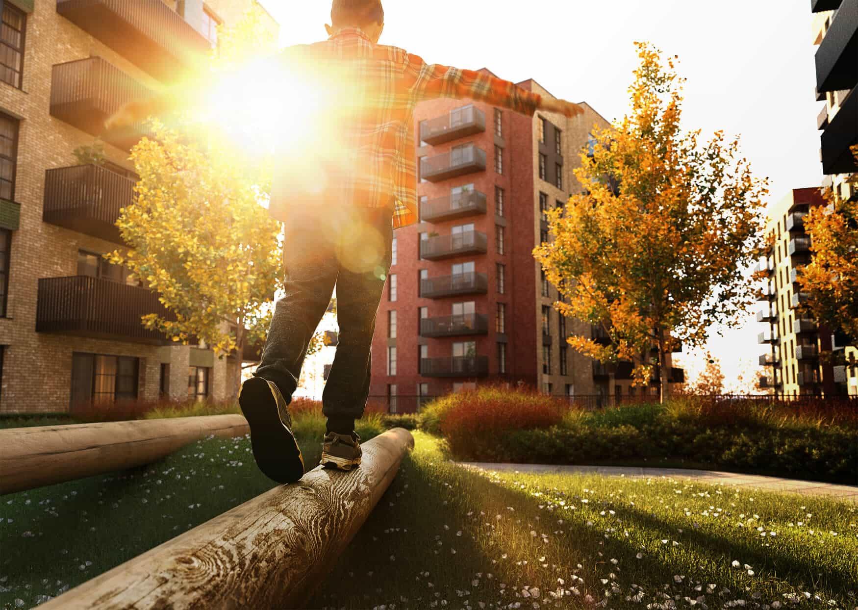 A man is walking on a log in Sterling Place Homes park