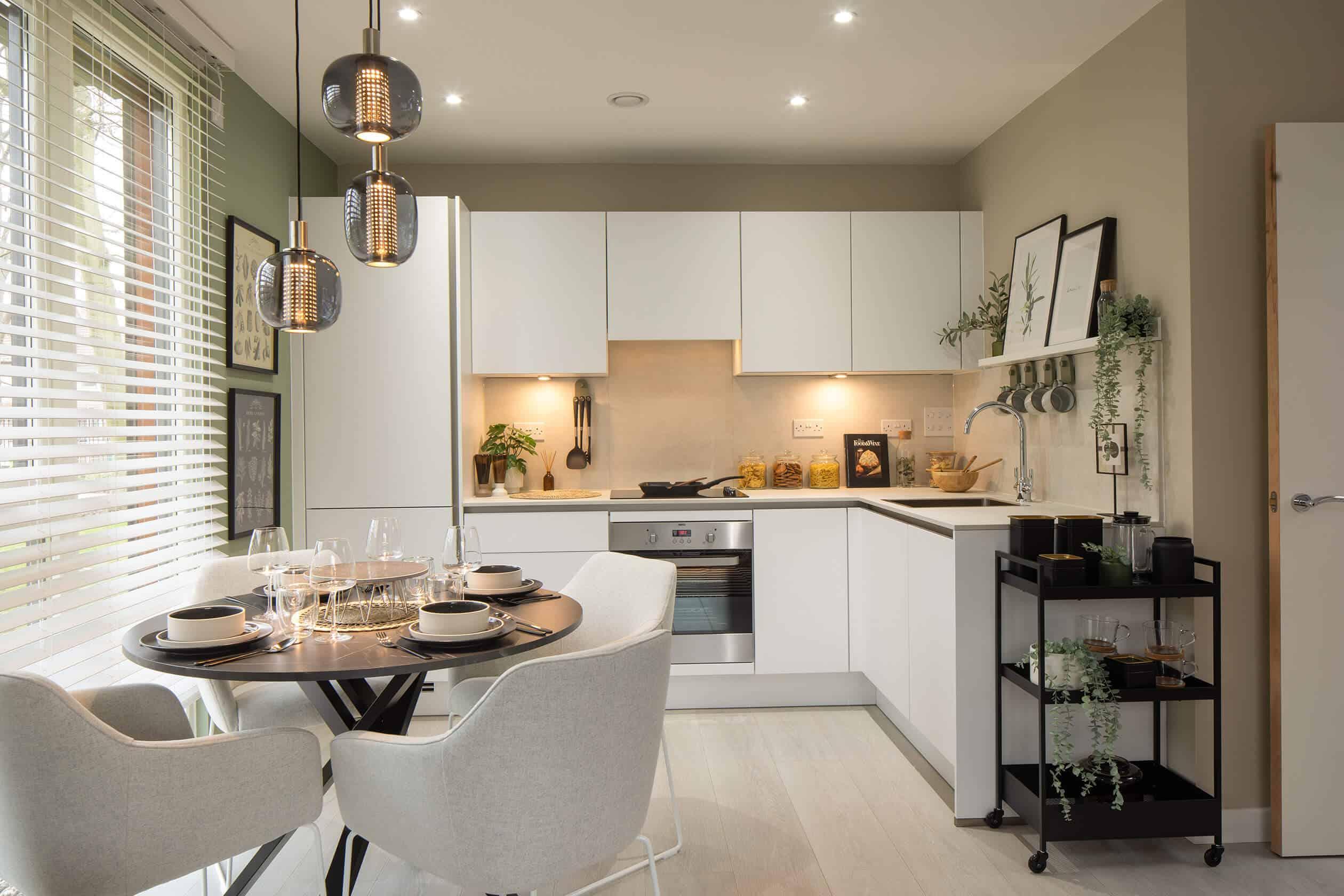 A modern apartment with a kitchen and dining area in Hayes Village Homes.