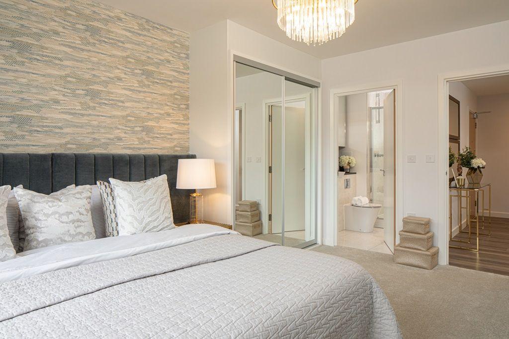 A Ridgeway Views Property with a bedroom featuring a large bed and a mirror