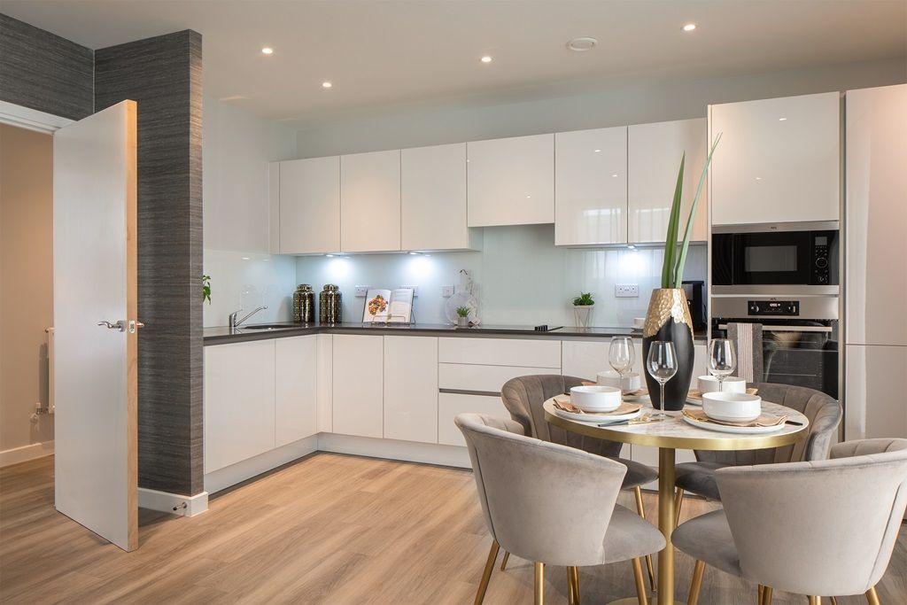 A modern kitchen with a dining table and chairs in the Ridgeway Views Property