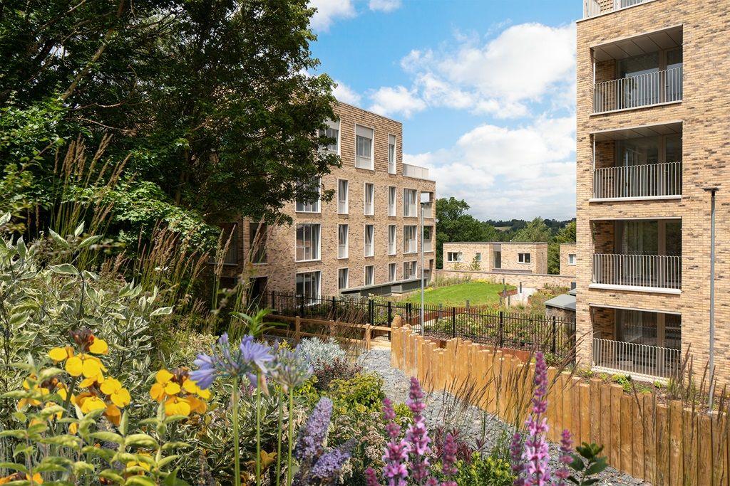 Ridgeway Views is enhanced by a garden adorned with colorful flowers and trees in front of the home