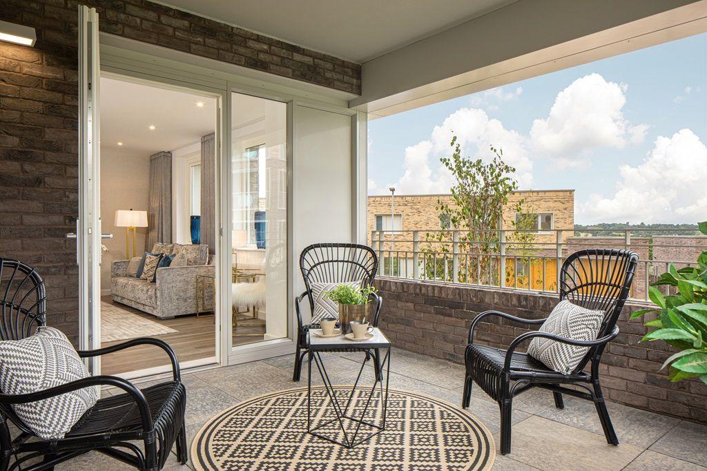 Ridgeway Views features a balcony adorned with furniture set against a charming brick wall