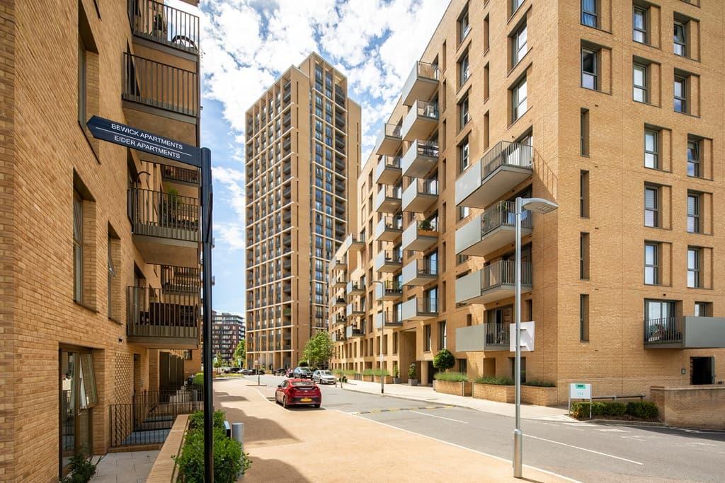 Hendon Waterside Homes featuring a car parked on a street next to tall buildings